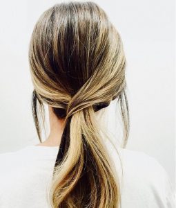 Woman from behind with casual hair style, showing sleek, natural-looking hair from Kevin.Murphy